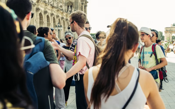 Tourists walking near an ornate historic European landmark